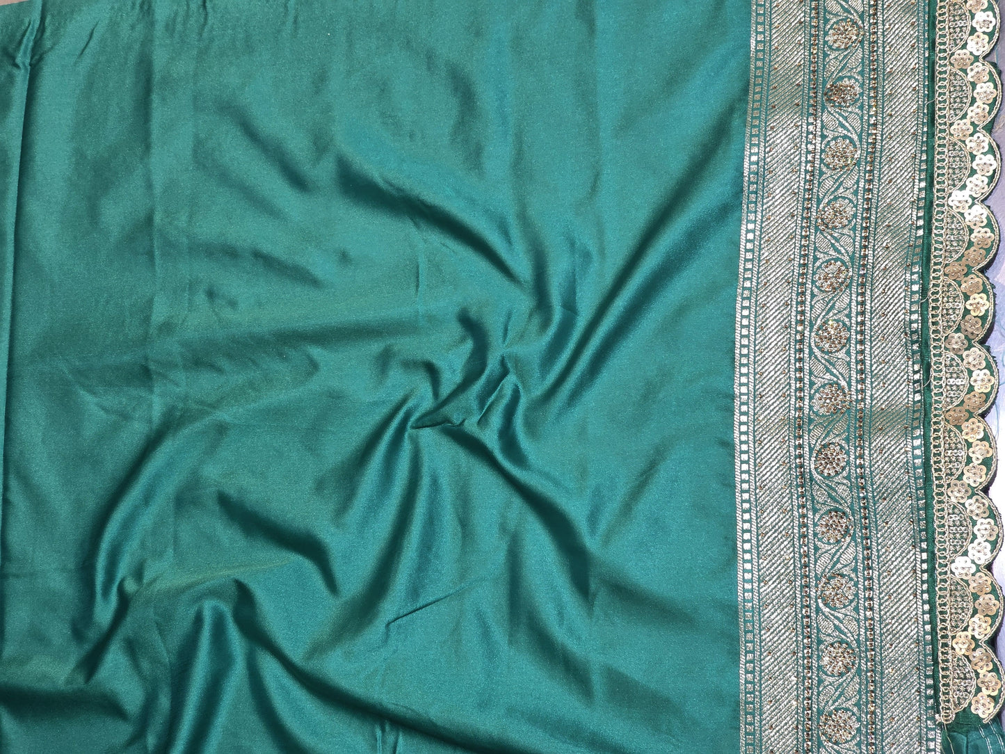 A rich semi-designer Banarasi saree with intricate veil artistry and silver zari highlights. Traditional grace for grand occasions.