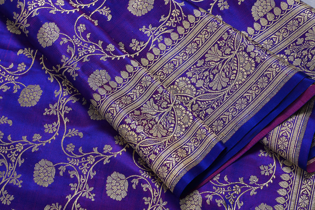 Close-up of a purple fabric with gold floral patterns