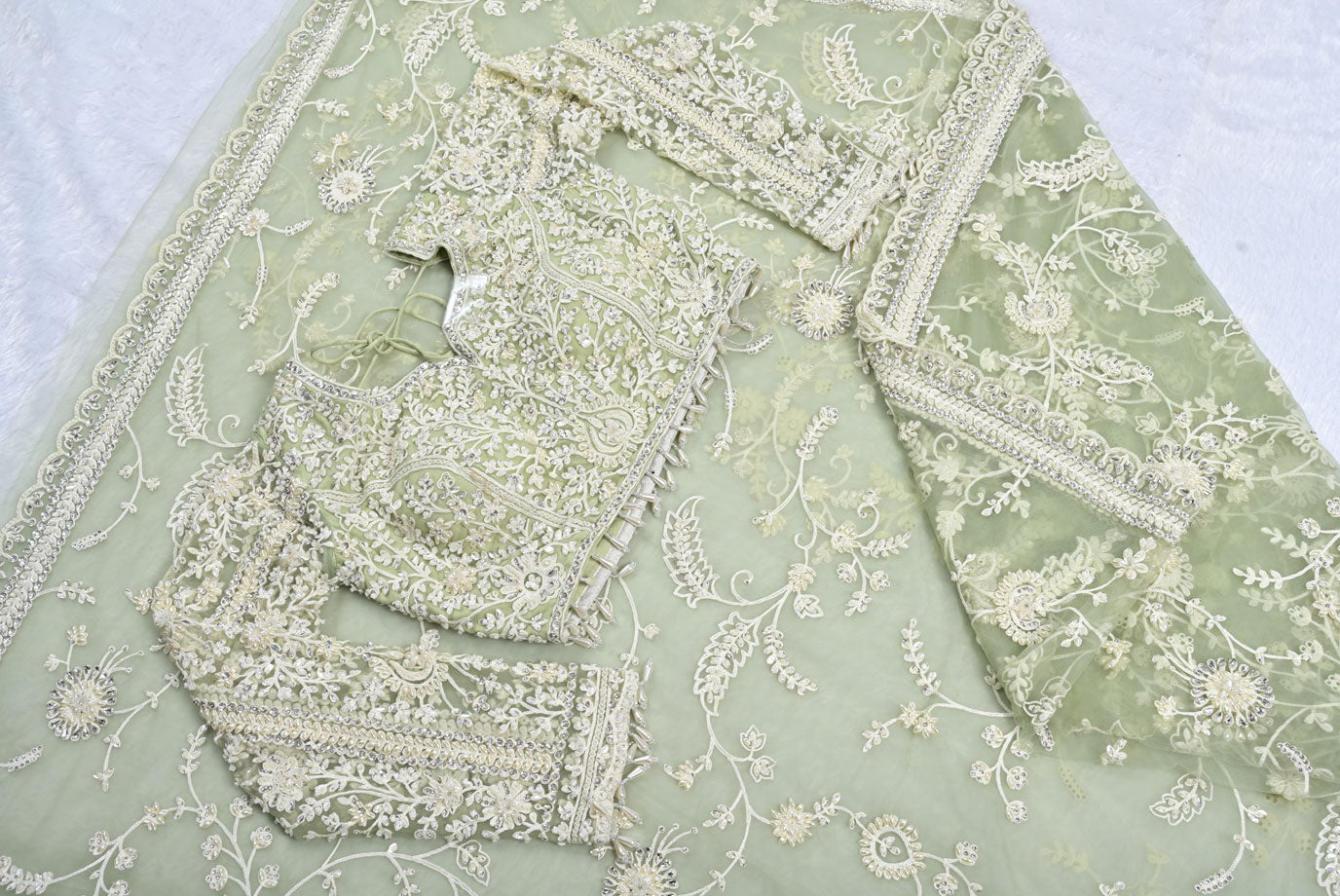 Fabric pista green net designer saree for weddings and festive occasions