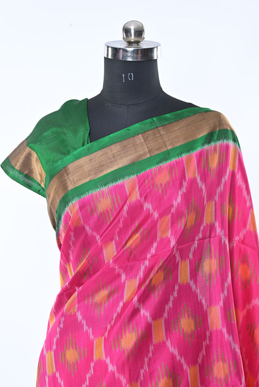 Saree with pink and green pattern on a mannequin against a white background