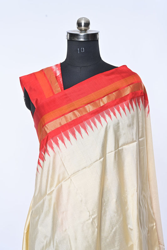 Saree with red and orange border on a mannequin against a white red kochampalli silk saree for weddings and festive occasionsbackground