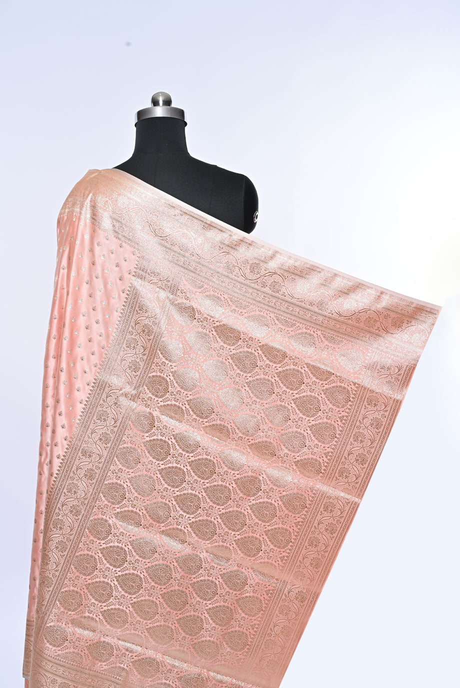 Pink saree with intricate patterns on a mannequin against a light gray backgroundBanarasi Soft Silk Baby Pink Saree for Wedding