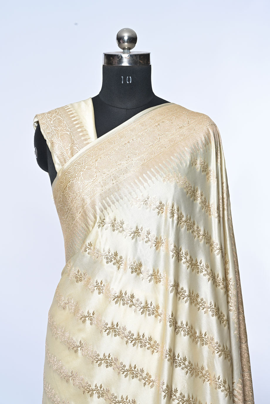 Half white Banarasi soft silk saree with golden zari sequence veil design and golden zari border, perfect for weddings and festive occasions.