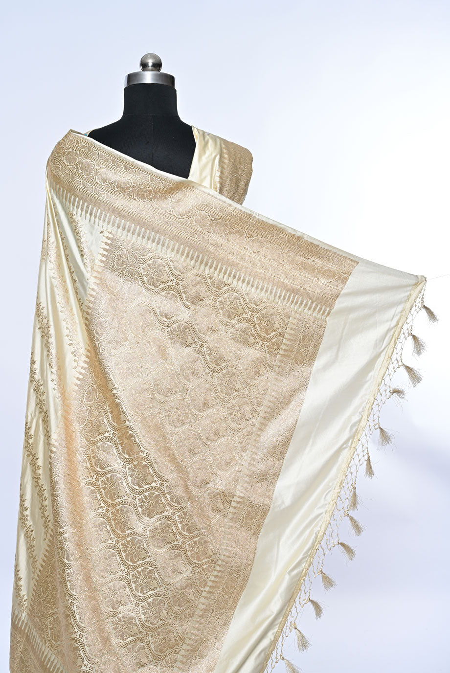 Half white Banarasi soft silk saree with golden zari sequence veil design and golden zari border, perfect for weddings and festive occasions.