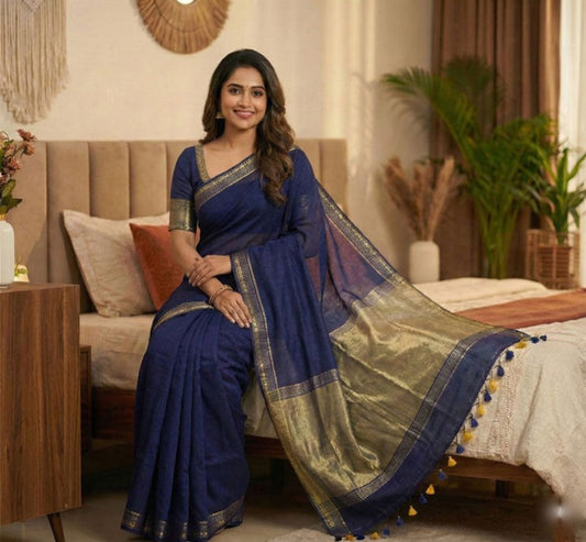 Ethnic navy blue cotton saree featuring butti design, rich copper zari pallu, and elegant golden border with tassels.
