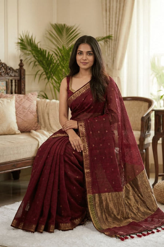 This beautiful maroon cotton saree comes with small elegant buttties, minimal border, and elegant copper zari pallu and tessels perfect for office and daily use .easy to wear.