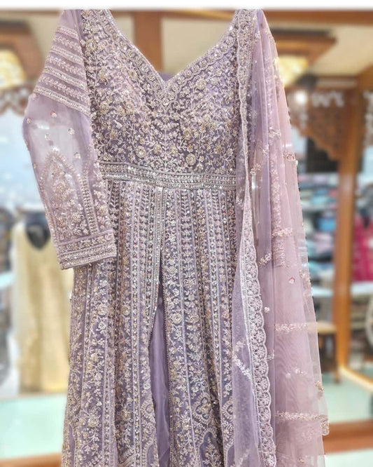 Dusty lavender front cut Anarkali gown with heavy zari and sequin embroidery and flared floor-length silhouette.