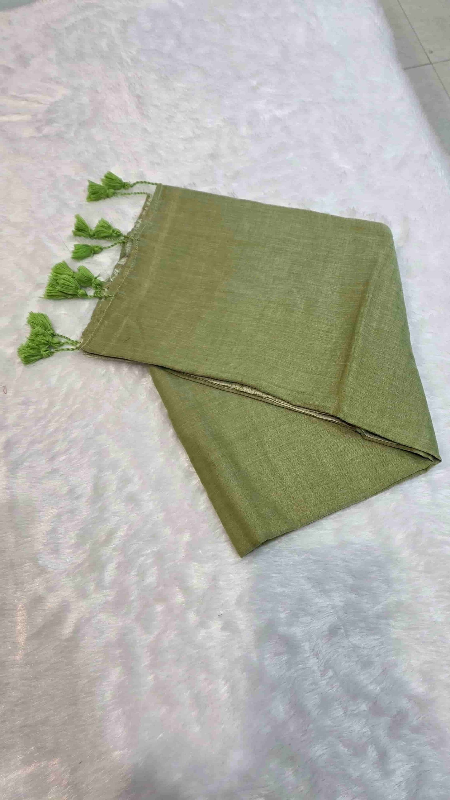 Plain olive green mulmul cotton saree with hand-tied tassels