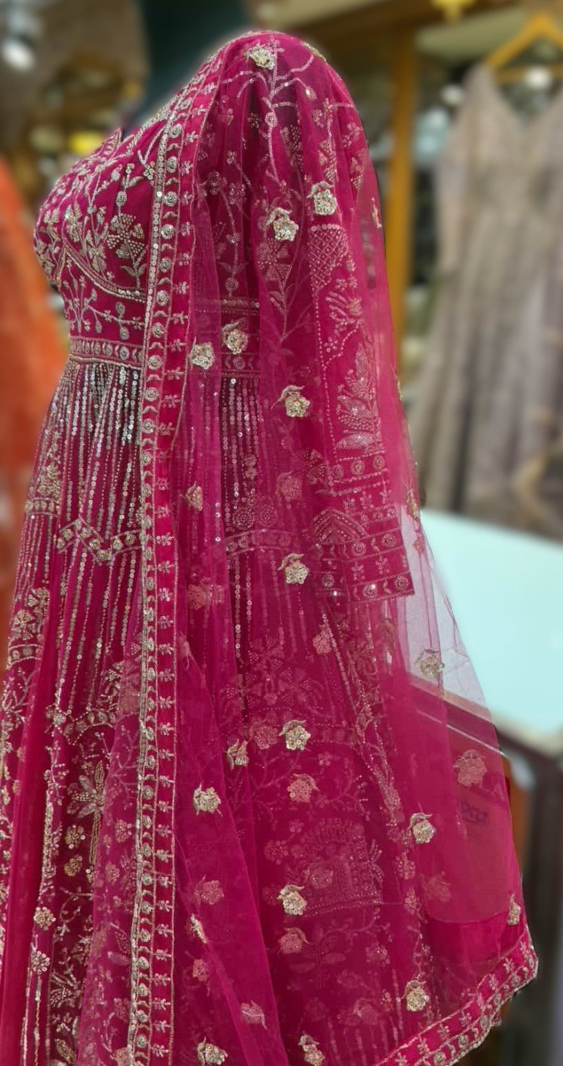Side view of rani pink net Anarkali gown with embroidered dupatta