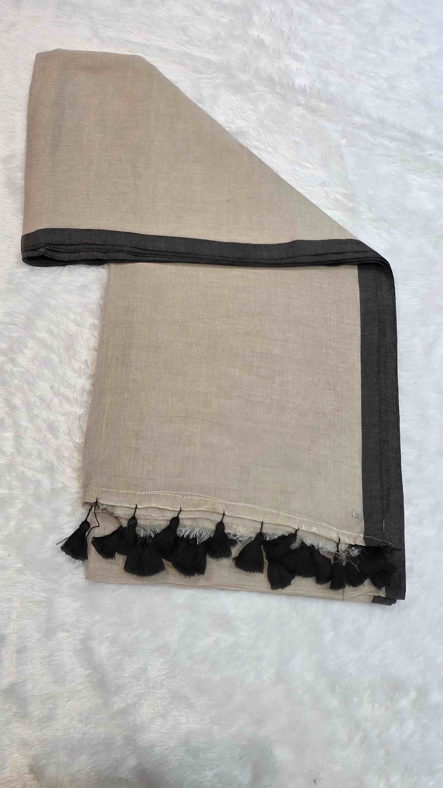 Lightweight beige mulmul cotton saree with black border and tassels