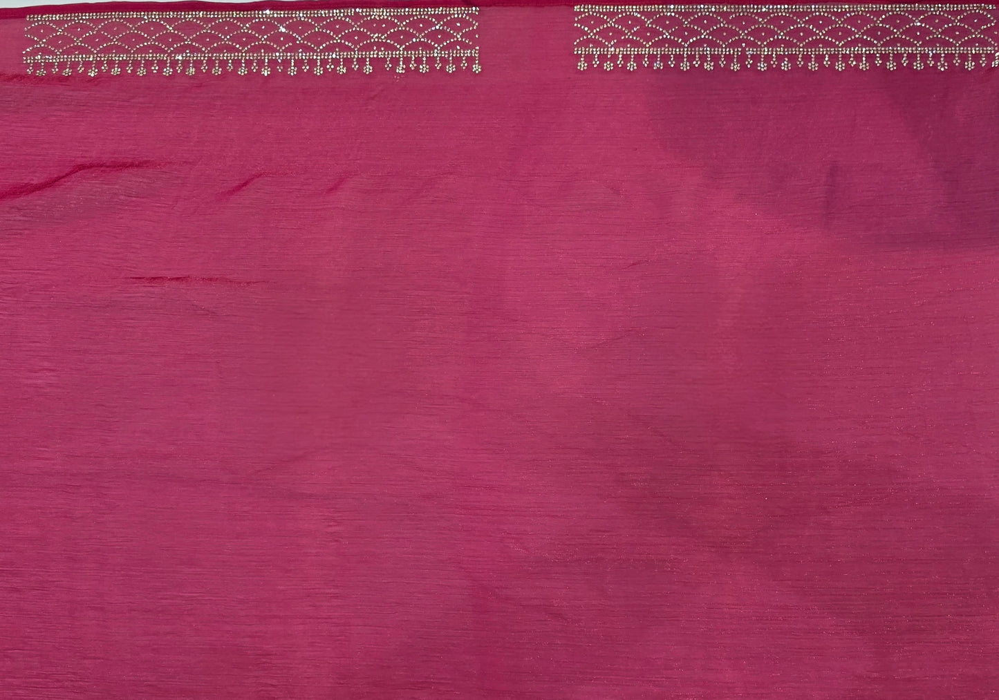 A luxurious baby pink pure satin silk saree adorned with delicate overall small stone work that gives a subtle festive sparkle. The saree is elevated with a contrast dark pink border, embellished with matching stone handwork, adding richness and definition to the drape. Paired with a dark pink contrast blouse, this saree is perfect for weddings, receptions, and special gatherings where timeless elegance is desired.