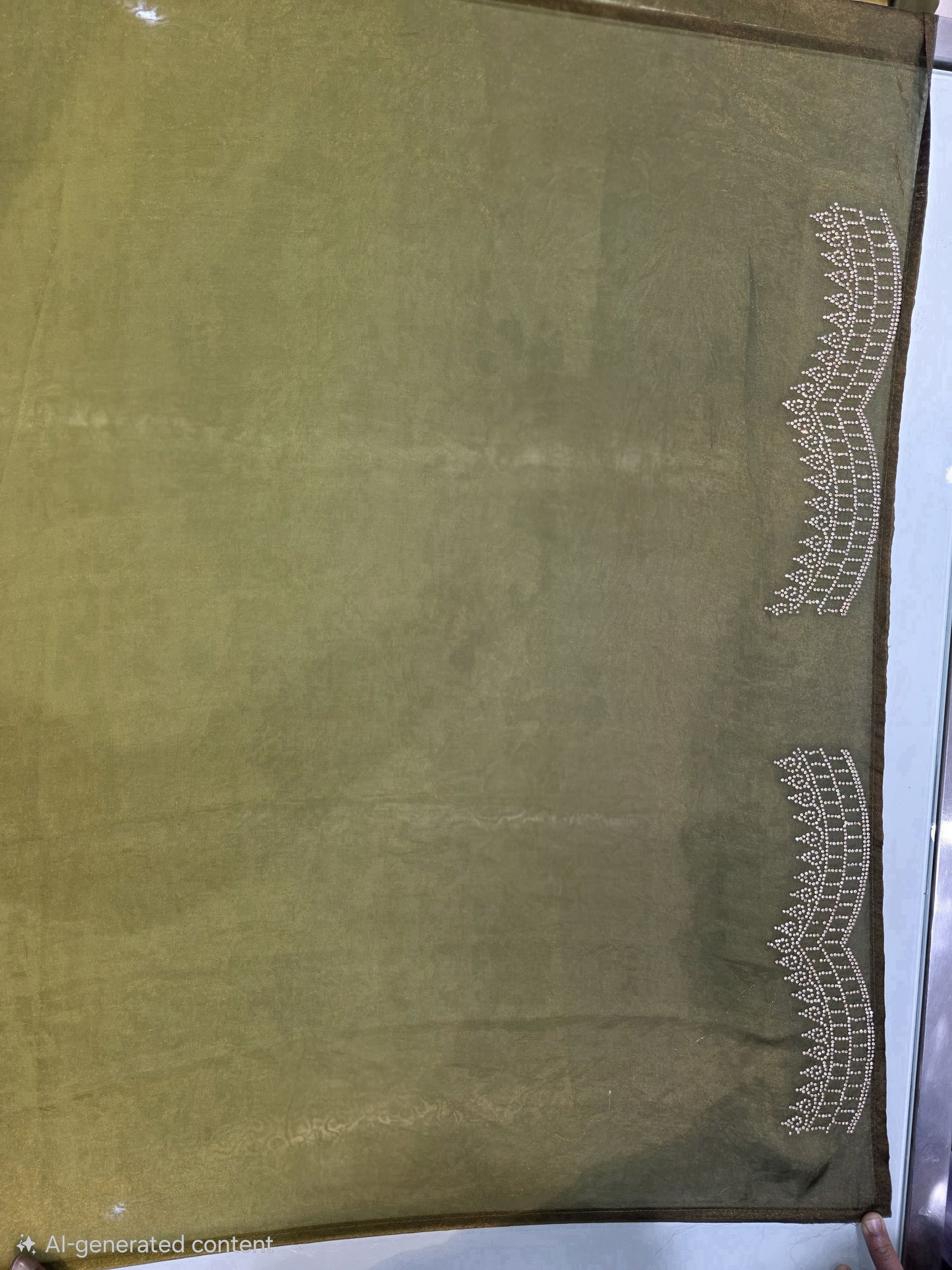A contemporary neon and bottle green pure satin silk saree featuring a plain body paired with a heavy stone-work necklace border, creating a stunning contrast. The rich border detailing adds a designer edge, while the running blouse maintains a coordinated look. This saree is perfect for pre-wedding functions, mehendi events, and fashionable festive wear.