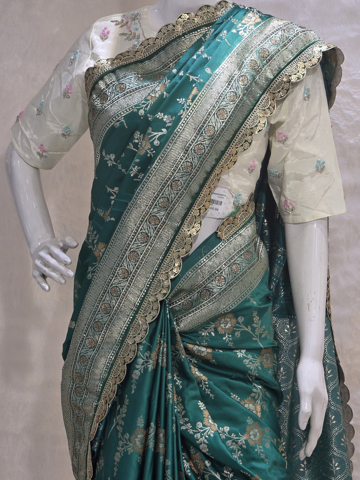 A rich semi-designer Banarasi saree with intricate veil artistry and silver zari highlights. Traditional grace for grand occasions.