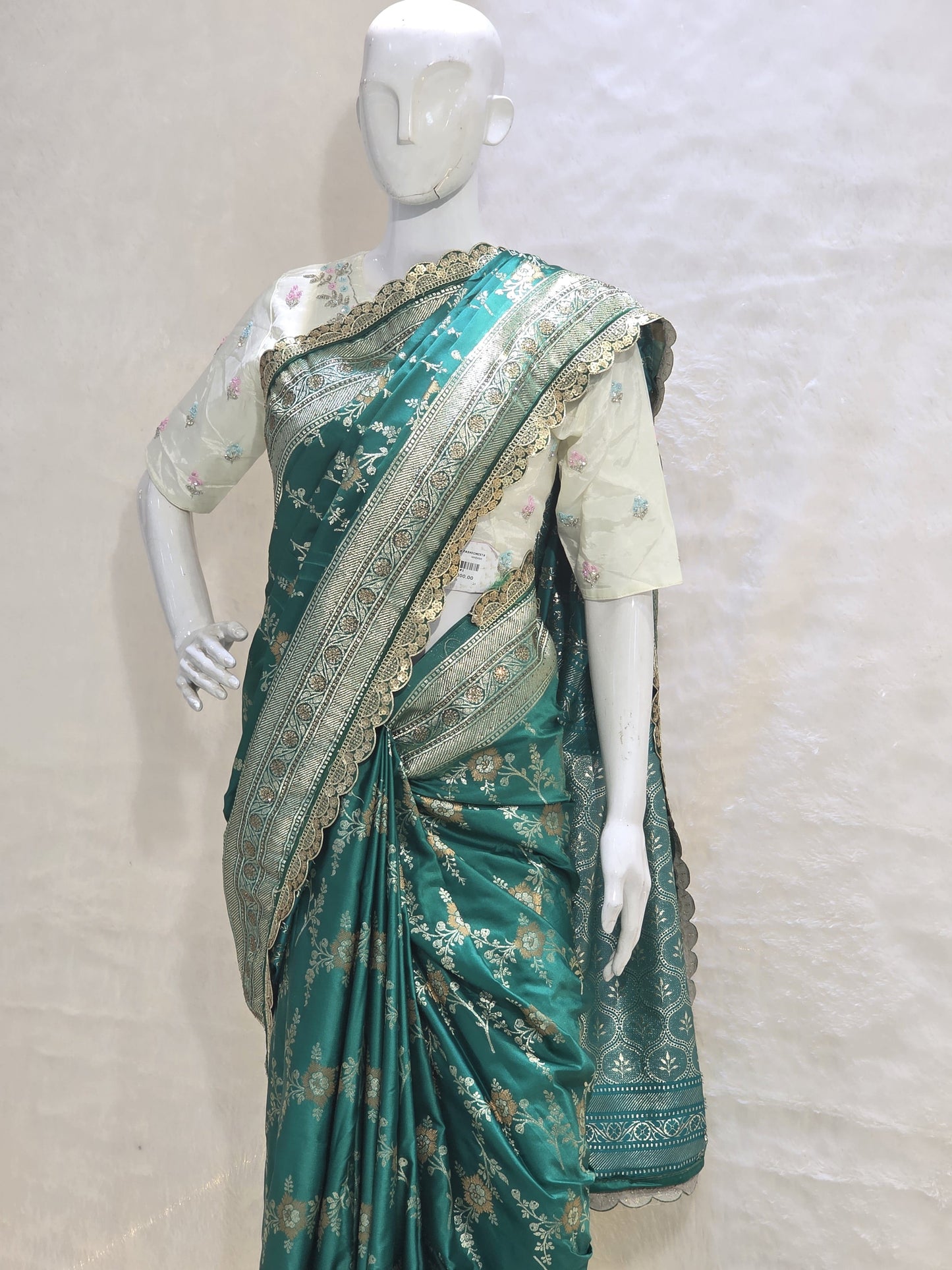 A rich semi-designer Banarasi saree with intricate veil artistry and silver zari highlights. Traditional grace for grand occasions.