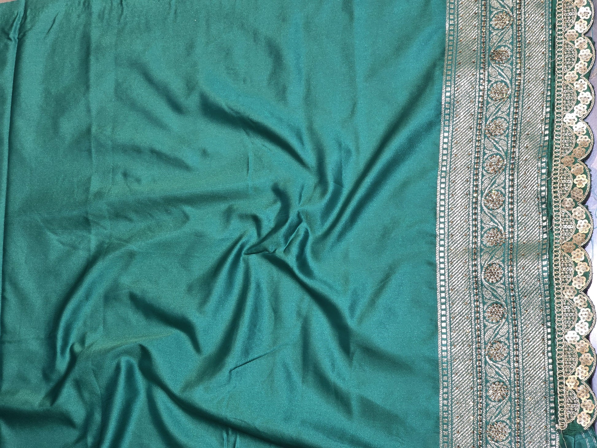 A rich semi-designer Banarasi saree with intricate veil artistry and silver zari highlights. Traditional grace for grand occasions.