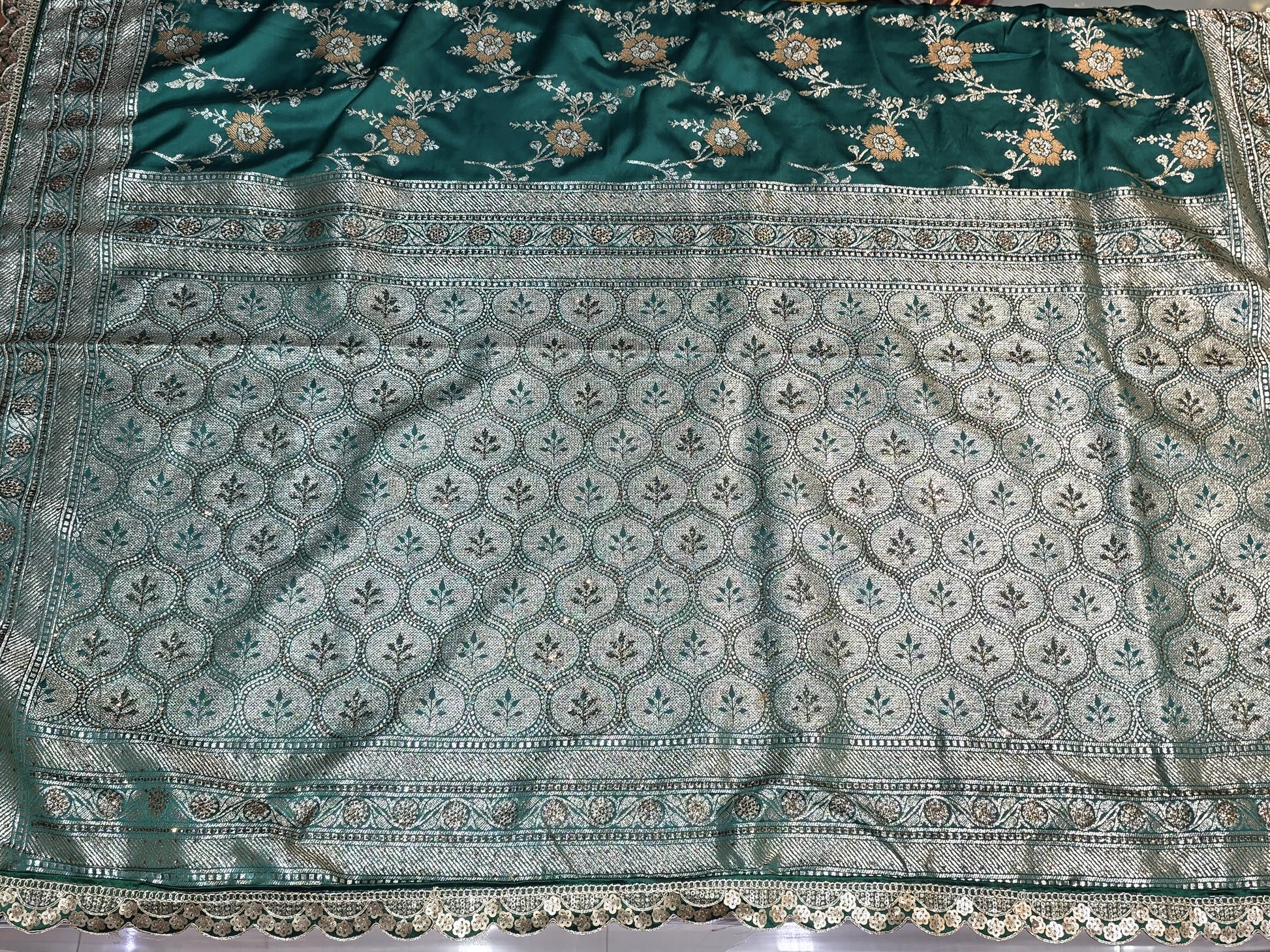 A rich semi-designer Banarasi saree with intricate veil artistry and silver zari highlights. Traditional grace for grand occasions.