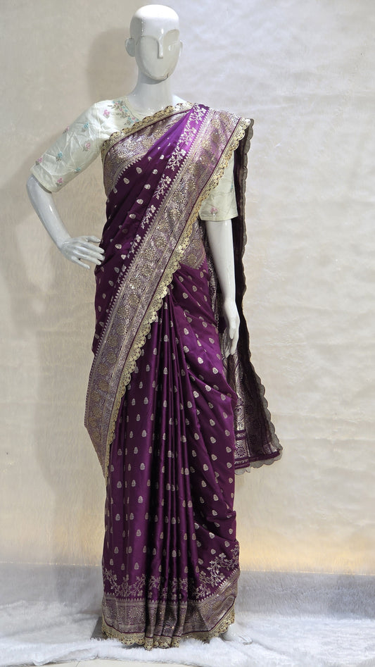 A semi-designer Banarasi saree adorned with shimmering silver zari buttis and a beautifully detailed cutwork border. Rich, elegant and perfect for weddings and festive celebrations.