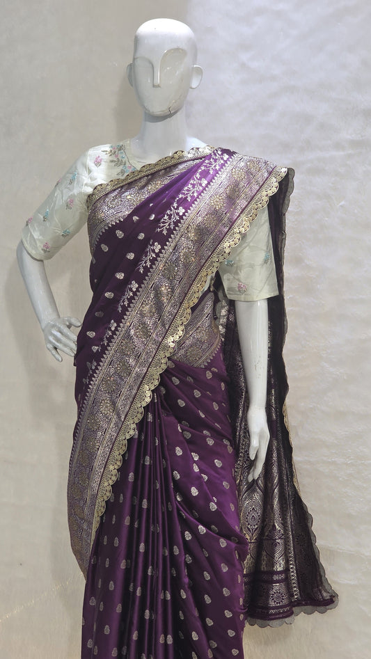 A semi-designer Banarasi saree adorned with shimmering silver zari buttis and a beautifully detailed cutwork border. Rich, elegant and perfect for weddings and festive celebrations.