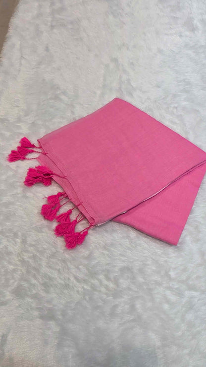 Bright pink cotton saree with subtle borders, self-blouse pattern, and tassels for office look.