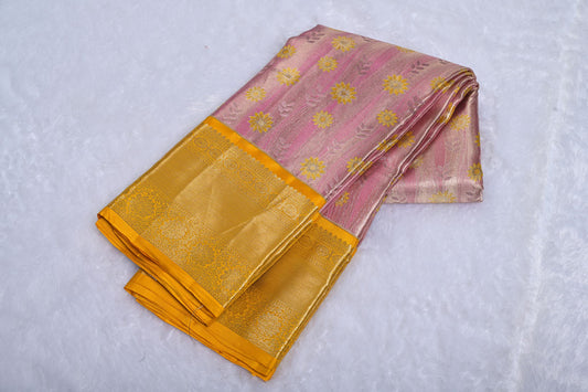 Pink and gold fabric with floral patterns on a white background Baby Pink Pure Kanjivaram Tissue Silk Saree with Yellow Floral Design and Golden Border