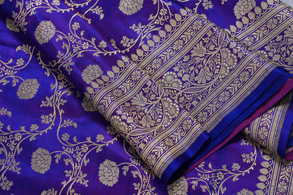 Close-up of a purple fabric with gold floral patterns