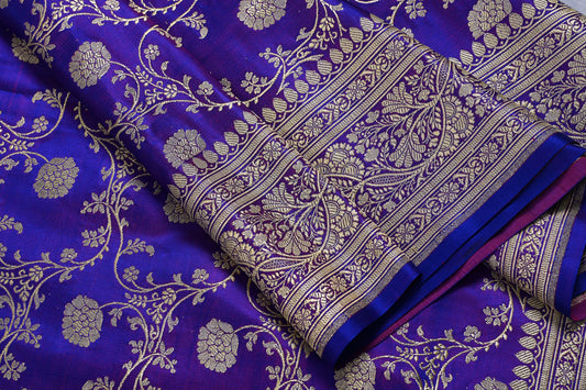 Close-up of a purple fabric with gold floral patterns