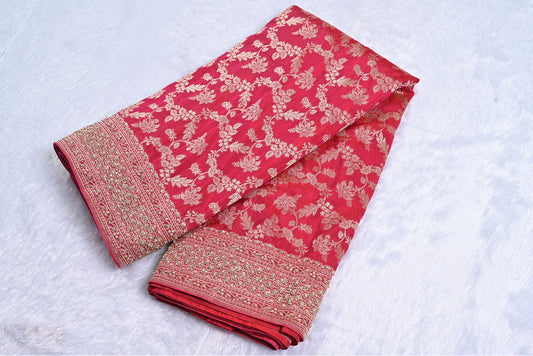 Red fabric with gold floral patterns on a white background