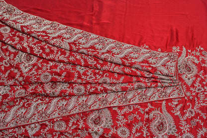 Red fabric with white floral patterns
Silk rani colour crape silk saree for weddings and festive occasions
