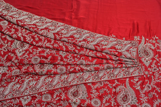Red fabric with white floral patterns
Silk rani colour crape silk saree for weddings and festive occasions