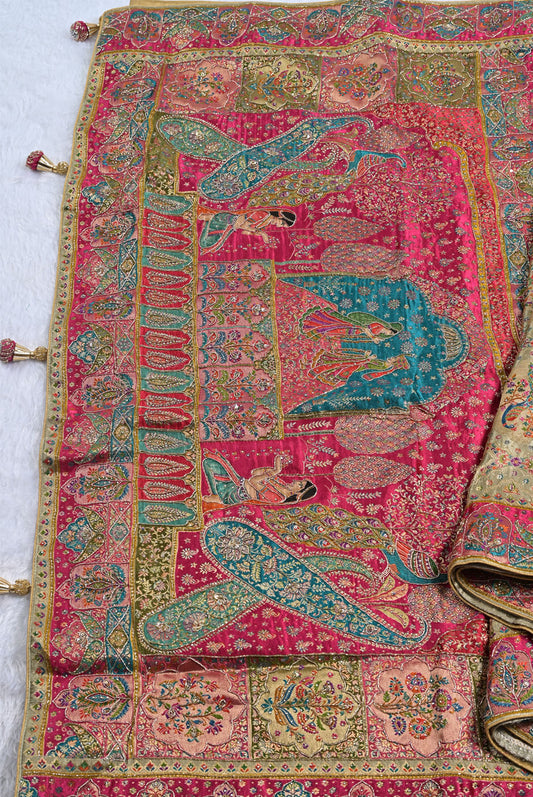 Colorful embroidered fabric with intricate patterns and figures on a white background