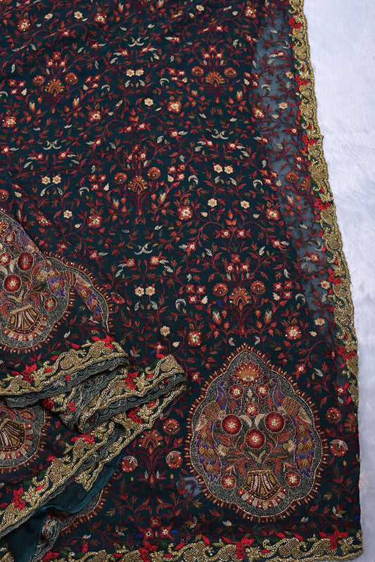 Close-up of a patterned fabric with intricate designs on a dark background