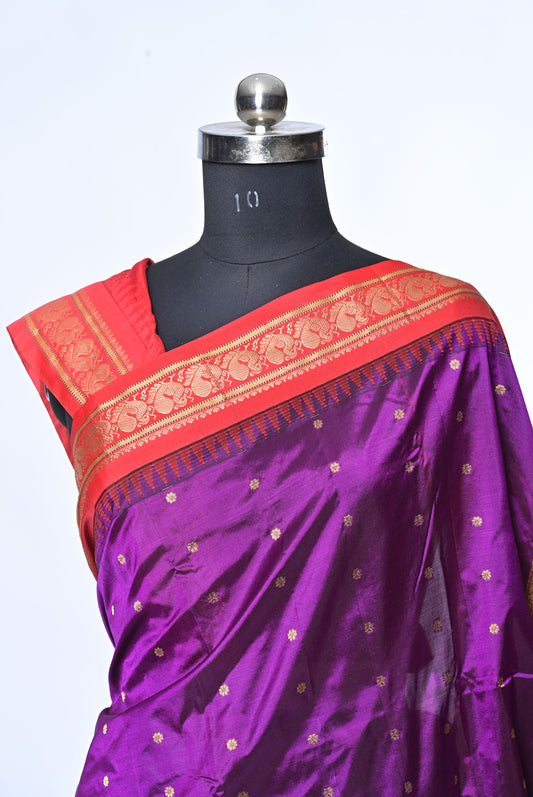 Purple saree with red border on a mannequin against a white background