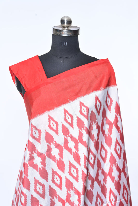 Red and white patterned fabric draped over a mannequin on a white background