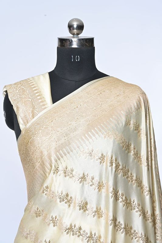 Half white Banarasi soft silk saree with golden zari sequence veil design and golden zari border, perfect for weddings and festive occasions.