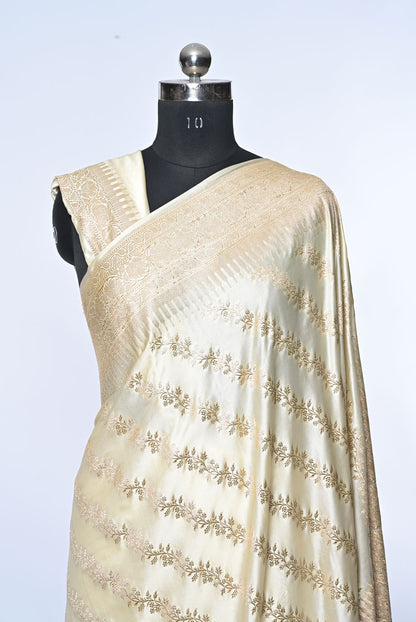 Half white Banarasi soft silk saree with golden zari sequence veil design and golden zari border, perfect for weddings and festive occasions.