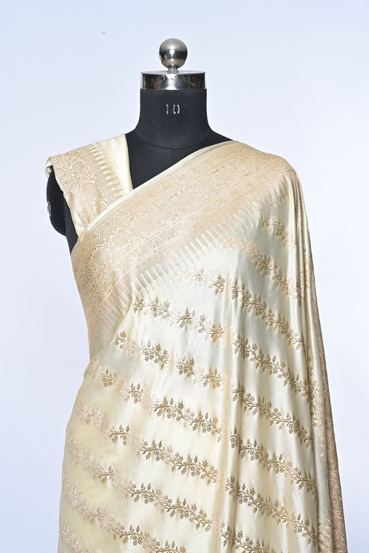 Half white Banarasi soft silk saree with golden zari sequence veil design and golden zari border, perfect for weddings and festive occasions.
