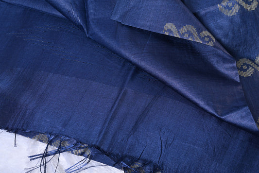Close-up of blue fabric with intricate patterns Silk nevy blue tussar silk saree for weddings and festive occasions