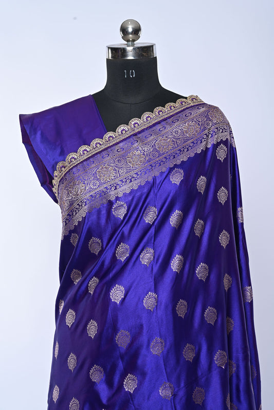 Blue saree with gold patterns on a mannequin against a white background