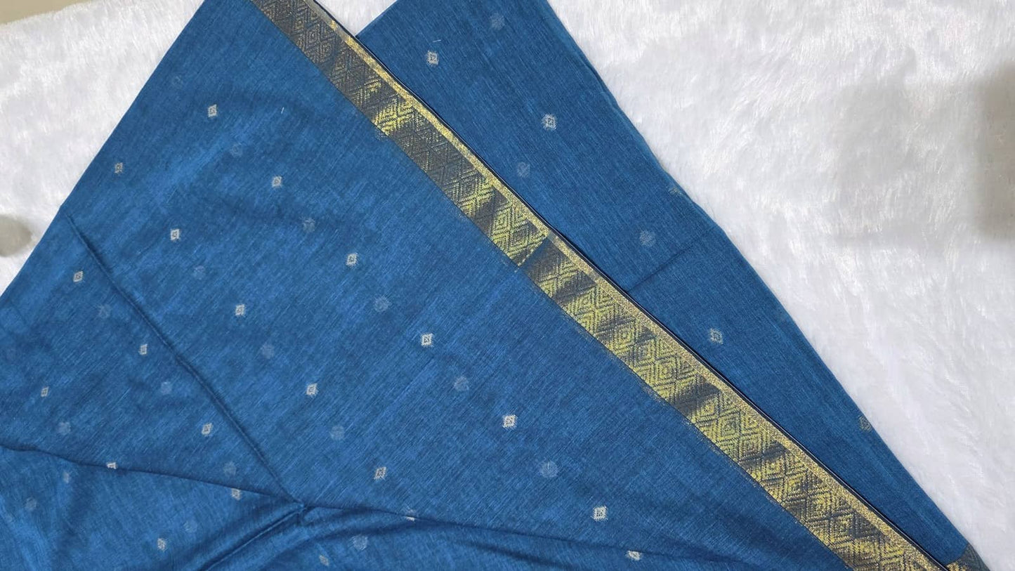 Teal blue festive cotton saree with detailed copper butti pattern, copper zari pallu, and traditional golden border.