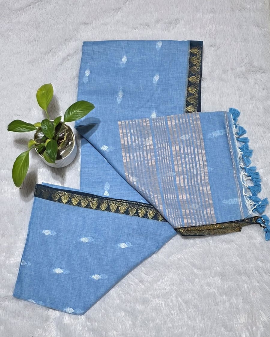 Sky blue ethnic cotton saree with silver butti weaving, golden stripe pallu design, and graceful golden border.
