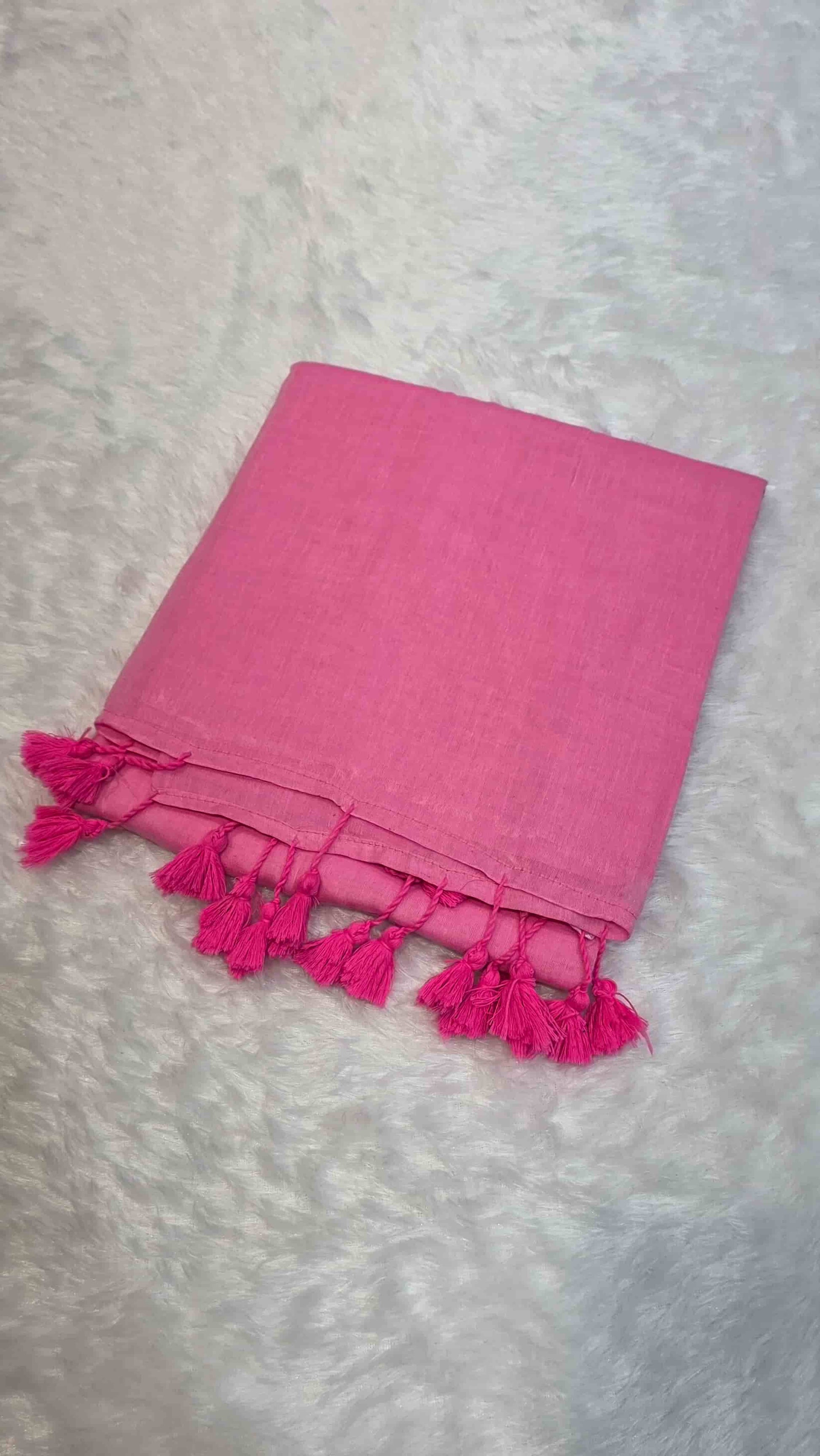 Soft bright pink cotton saree with minimal design and tassels, ideal for daily office wear.