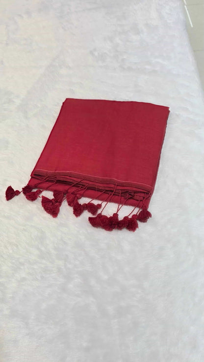 Red cotton saree with minimal border and tassels, comfortable for daily office styling.