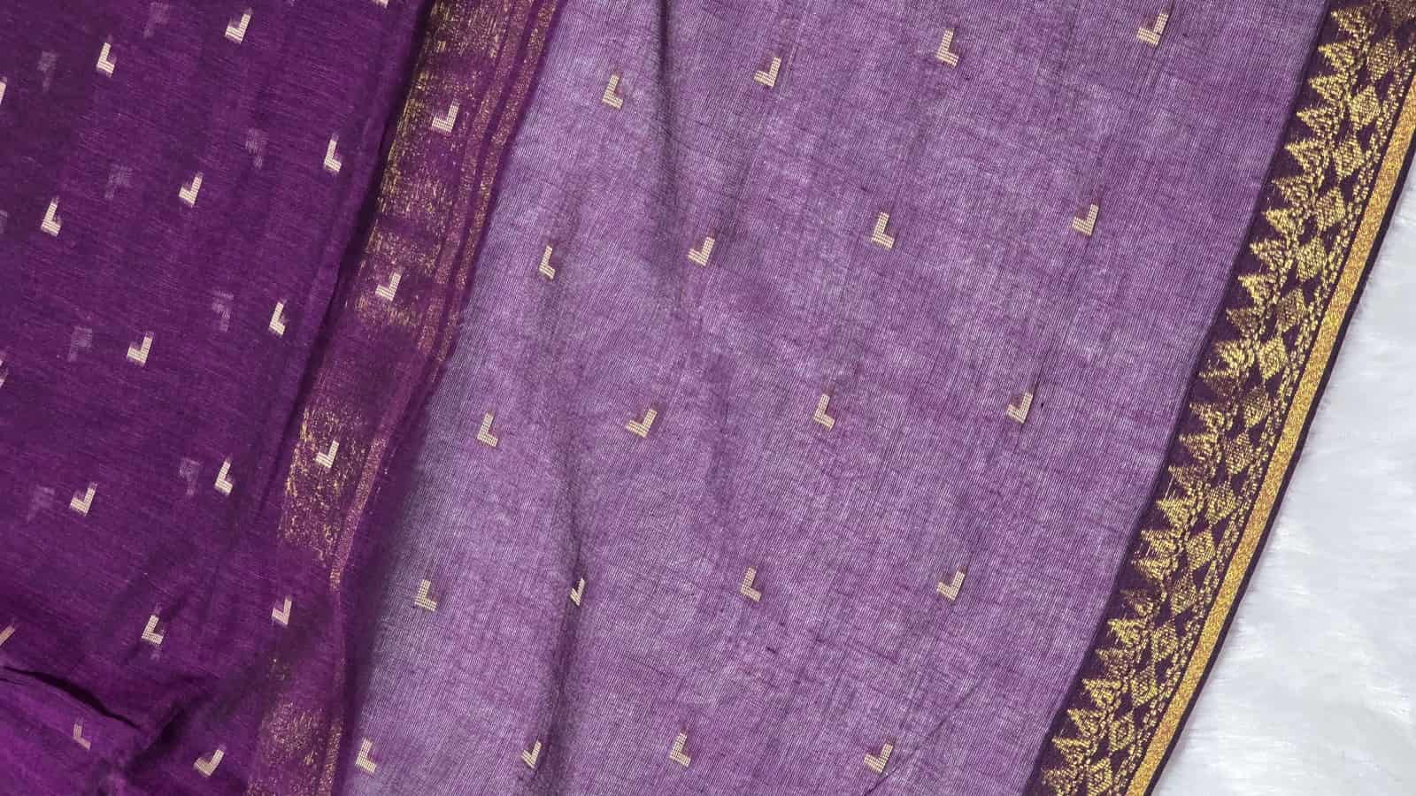 Purple fabric with gold patterns on a white background