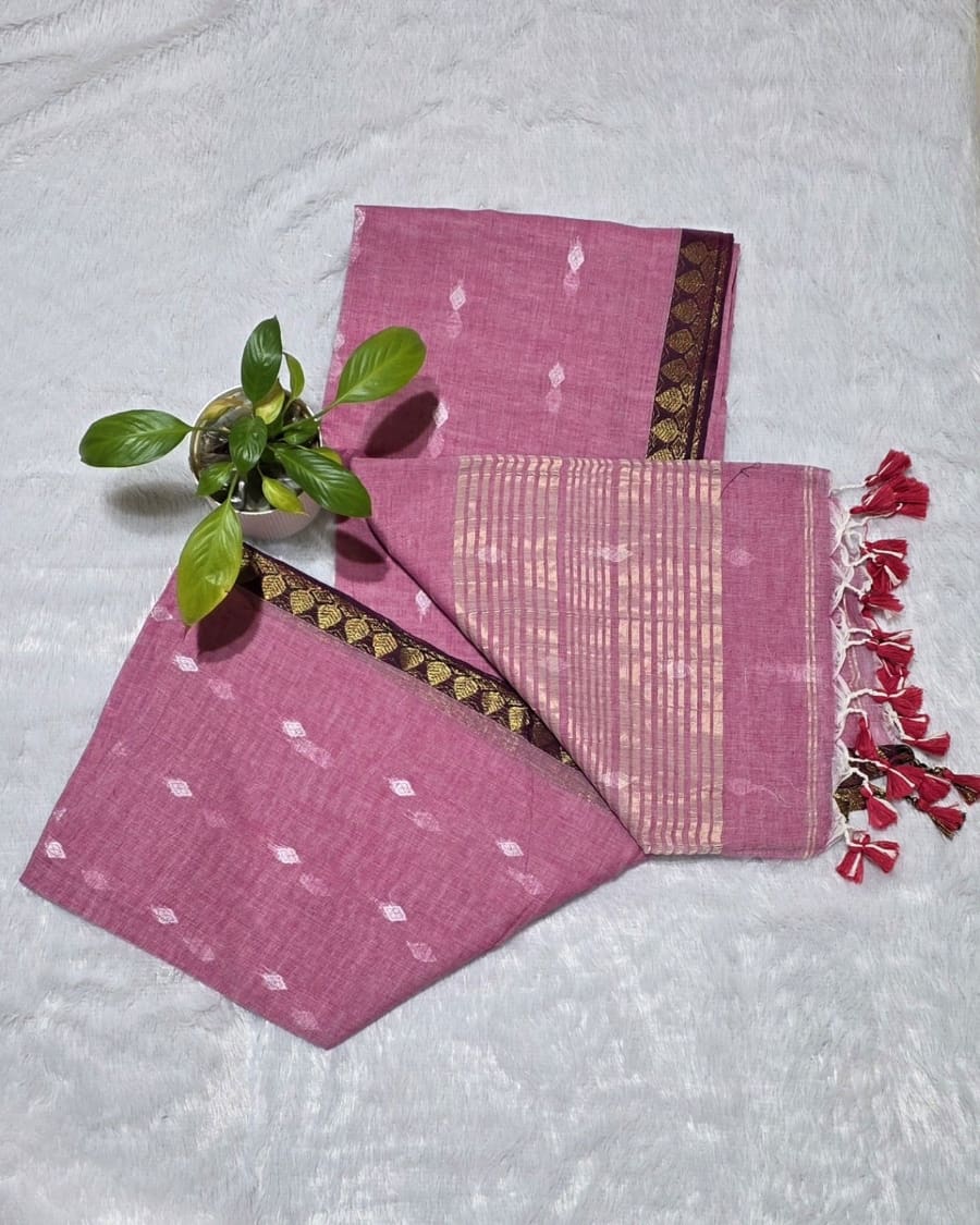 Baby pink pure cotton saree featuring all-over silver butti work, golden line stripe pallu design and golden border
