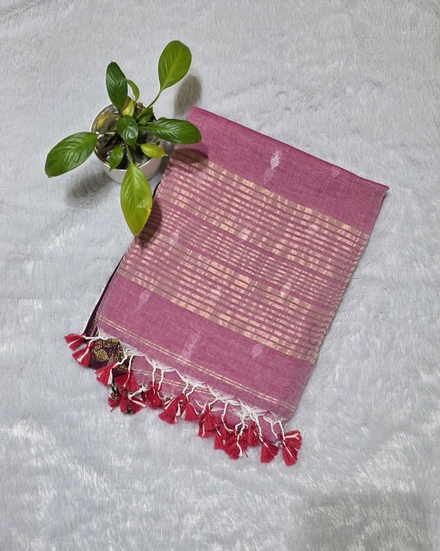 Baby pink pure cotton saree featuring all-over silver butti work, golden line stripe pallu design and golden border
