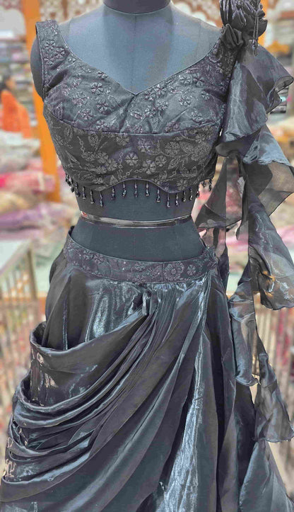 Close-up of floral embroidered black blouse with sculpted neckline and hanging bead tassels