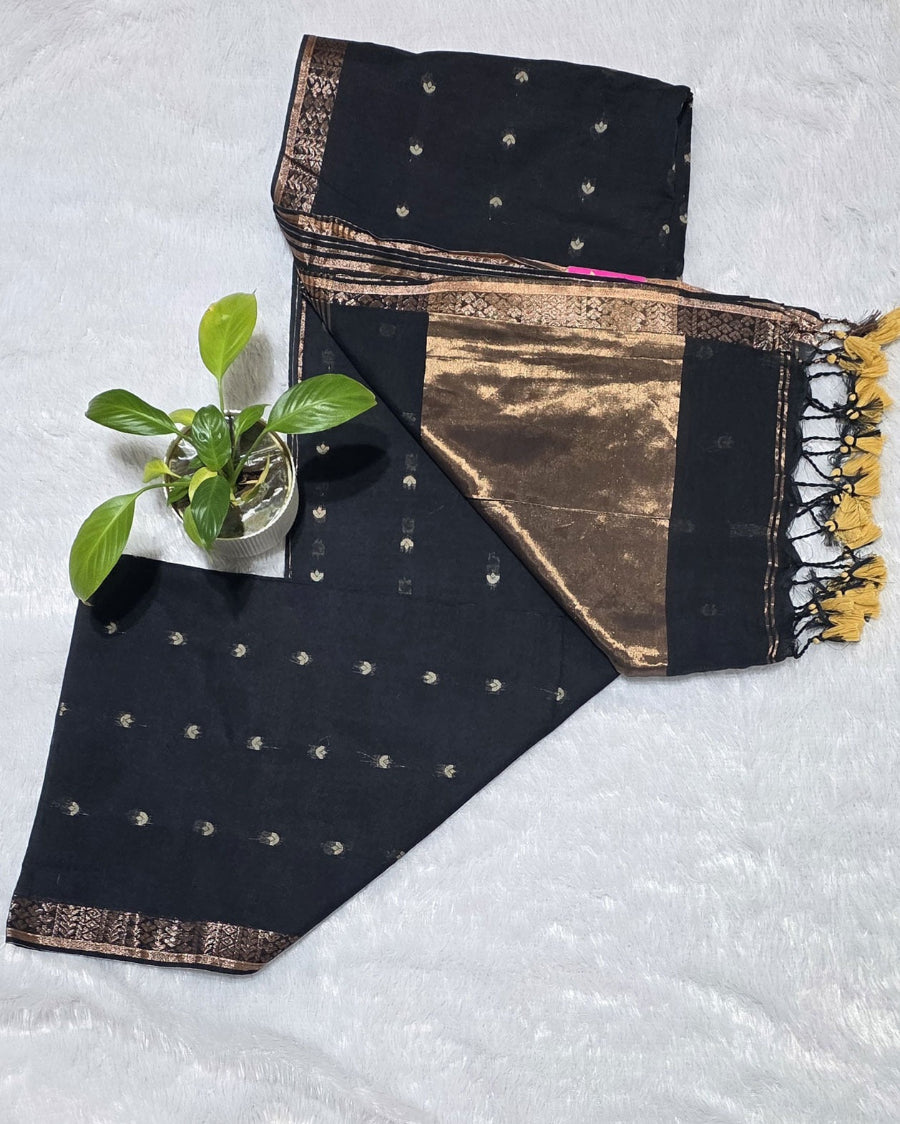 Black pure cotton saree with all-over butti design, copper zari pallu work and simple golden border with tassels.perfect for office wear , daily wear and festivals.
