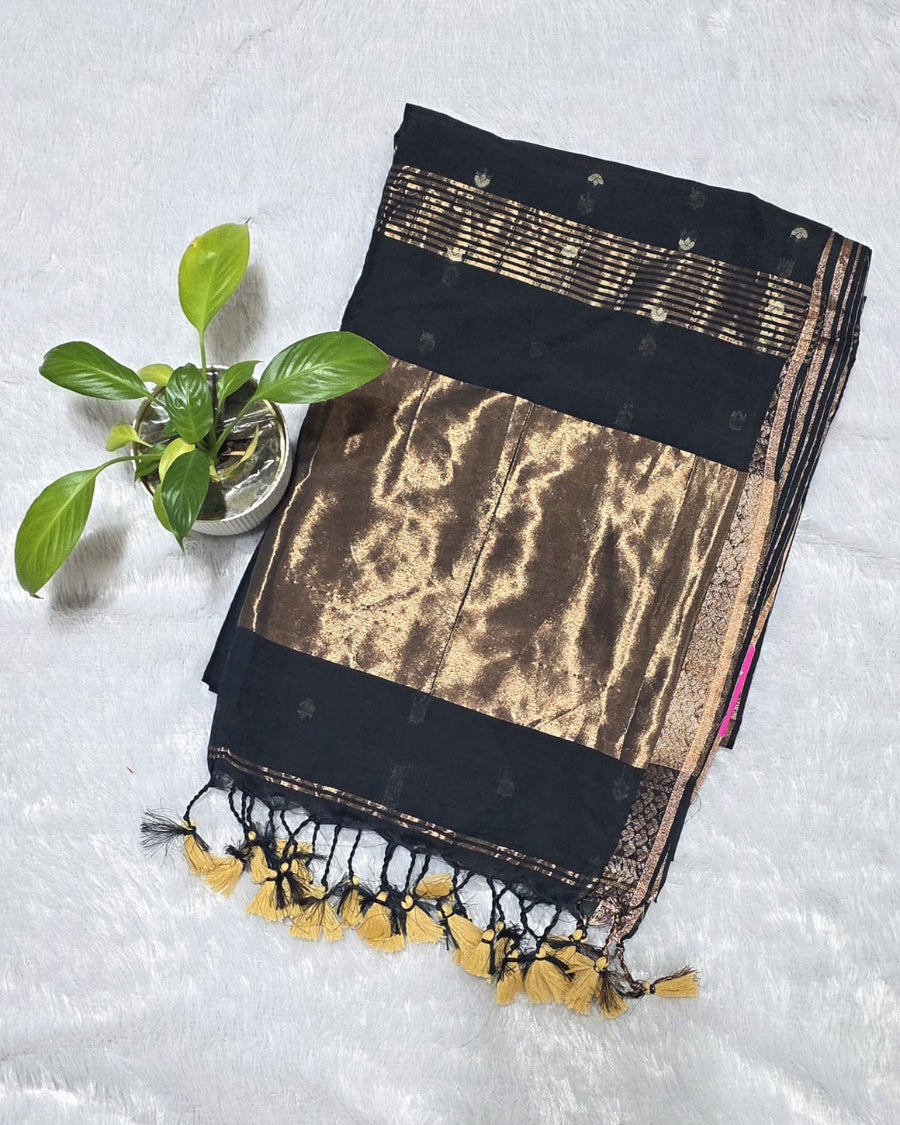 Black pure cotton saree with all-over butti design, copper zari pallu work and simple golden border with tassels.perfect for office wear , daily wear and festivals.
