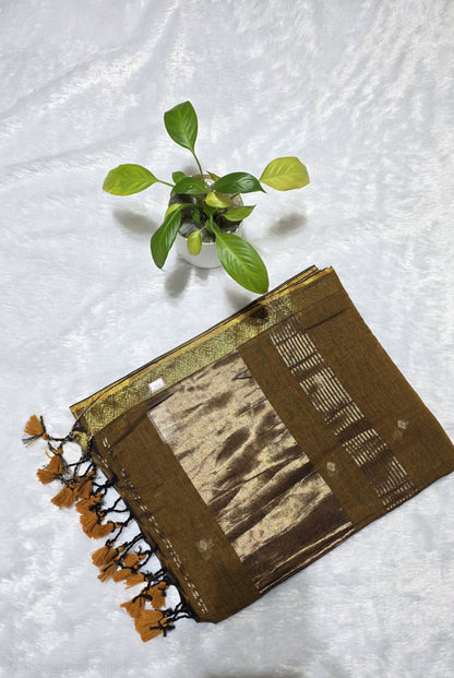 This is a coffee brown cotton saree with beautifully woven small butties and elegant border with copper zari pallu perfect for family gatherings and daily use