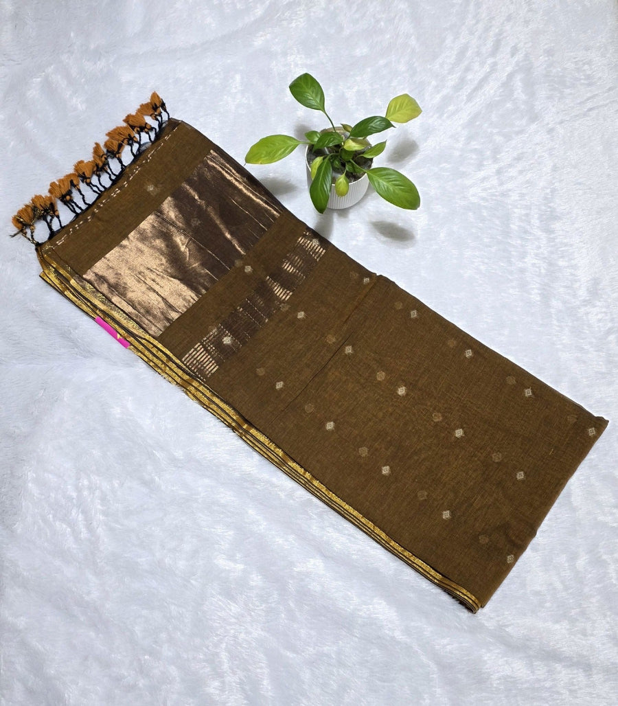 This is a coffee brown cotton saree with beautifully woven small butties and elegant border with copper zari pallu perfect for family gatherings and daily use